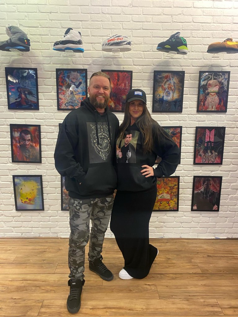 Couple in store with custom hoodies